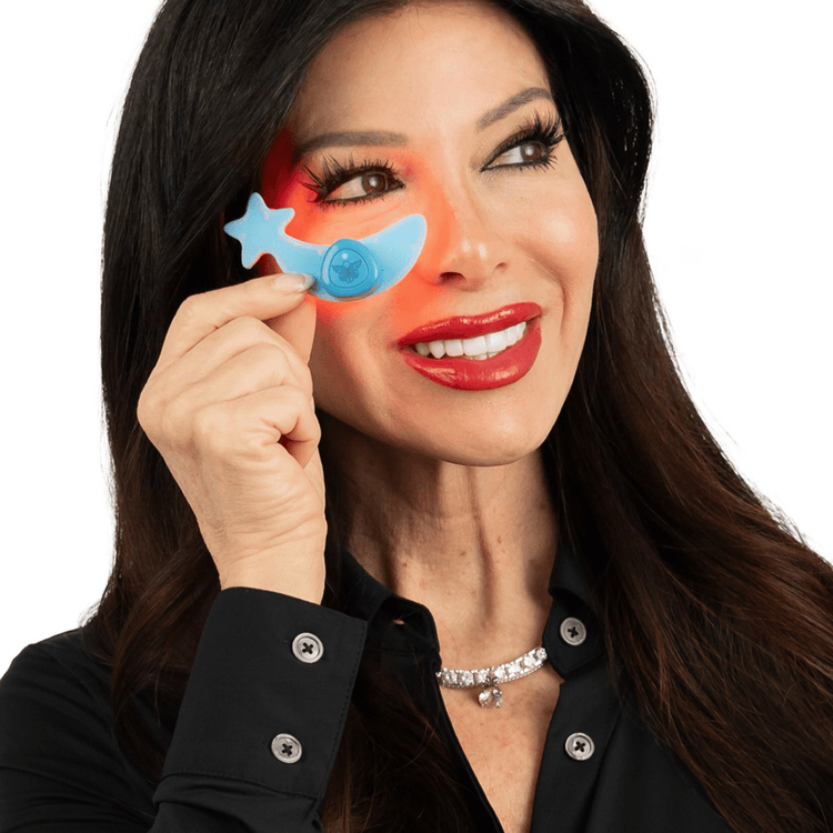 Woman holding a blue star-shaped device near her eye.