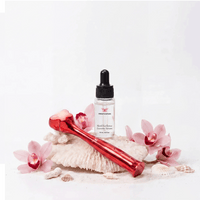 Metamorphosis RubyRadiance Ultimate Glow Kit featuring the red light therapy wand and SkinEXcellence Exosome Serum on white coral.