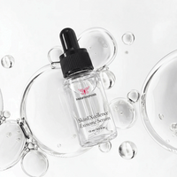 Metamorphosis SkinEXcellence Exosome Serum 15ml dropper bottle displayed flat-lay on a clean white background with clear, floating liquid serum bubbles.