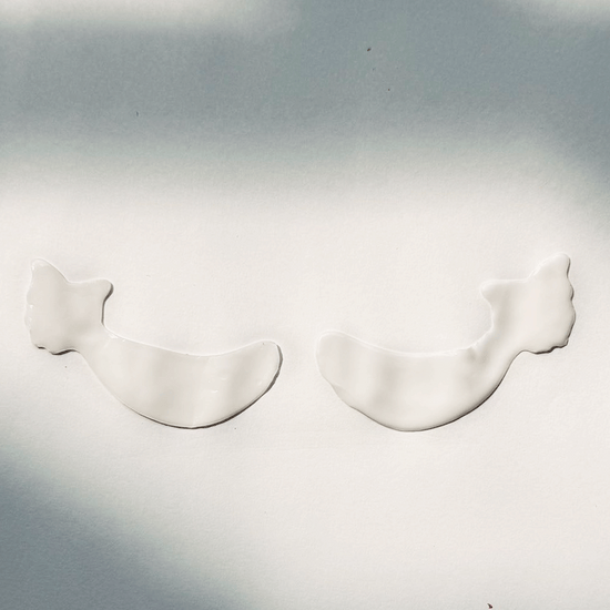 Two white, wing-shaped Metamorphosis Absorbable Bio-Collagen Eye Masks on a white background, highlighting the physical appearance of the eye patches for under-eye recovery and hydration.